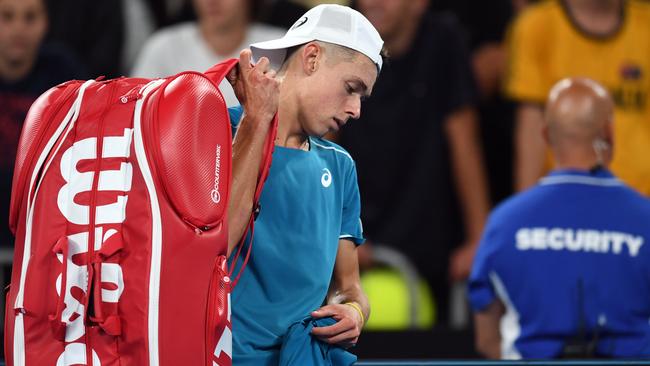 Alex de Minaur of Australia reacts after being defeated by Tomas Berdych of the Czech Republic during round one, on day two of the Australian Open tennis tournament, in Melbourne, Tuesday, January 16, 2018. (AAP Image/Lukas Coch) NO ARCHIVING, EDITORIAL USE ONLY