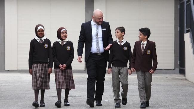 Principal Alan Khoder chats with students Ramla Ahmed, Aliyah Zainuddin, Moussa Rima and Mohamed Shaddad.