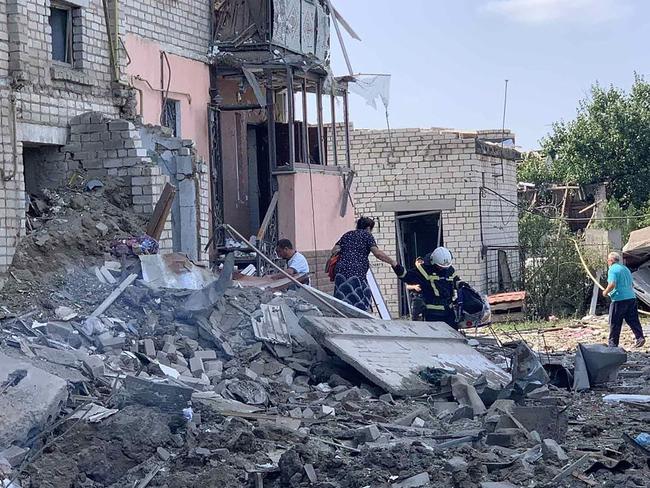 People evacuating from a destroyed residential building after a shelling in the town of Voznesensk. Picture: AFP