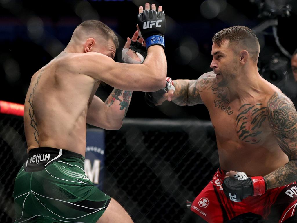 Conor McGregor and Dustin Poirier exchange blows in the first round in their lightweight bout during UFC 264. (Photo by Stacy Revere/Getty Images)