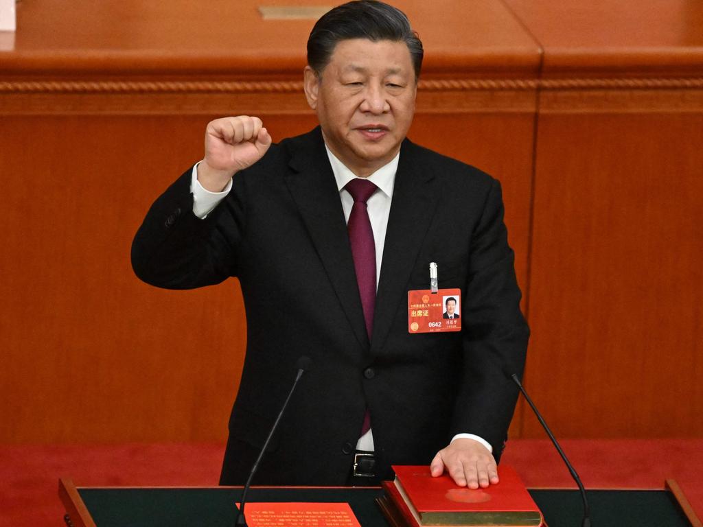 China's President Xi Jinping swears under oath after being re-elected as president for a third term during the third plenary session of the National People's Congress.