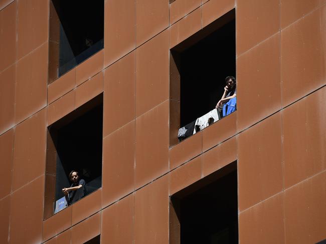 ADELAIDE, AUSTRALIA - NewsWire Photos - NOVEMBER 25, 2020 - Quarantined guests on their balcony at Peppers Waymouth Street Hotel in the CBD where the Parafield cluster originated. Picture: NCA NewsWire / Naomi Jellicoe