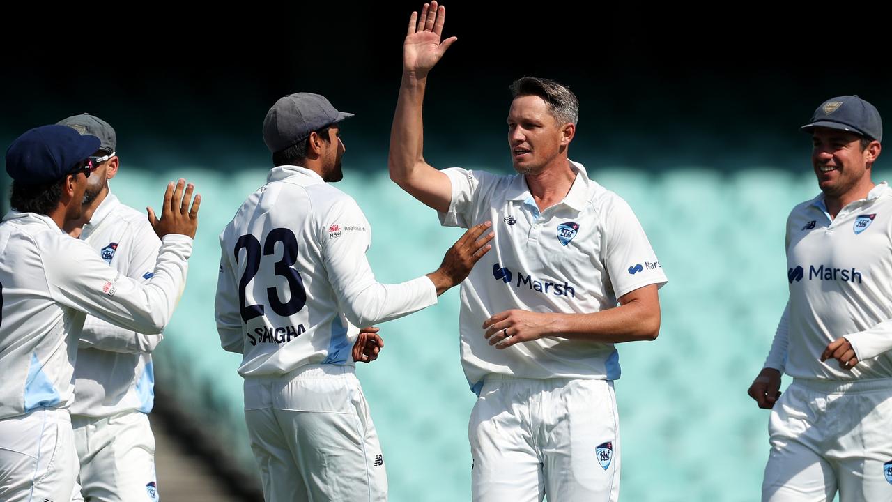 Chris Tremain celebrates his five-wicket haul with NSW teammates on the way to a drought-breaking win over Sheffield Shield holders Western Australia at the SCG. Picture: Matt King / Getty Images