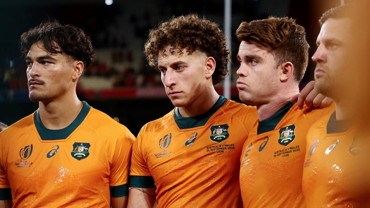 LYON, FRANCE - SEPTEMBER 24: Jordan Petaia, Mark Nawaqanitawase and Andrew Kellaway of Australia looks dejected as the players of Australia form a huddle at full-time following the Rugby World Cup France 2023 match between Wales and Australia at Parc Olympique on September 24, 2023 in Lyon, France. (Photo by Chris Hyde/Getty Images)