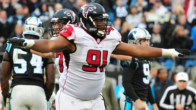 Corey Peters #91 of the Atlanta Falcons celebrates after a missed field goal attempt by the Panthers.