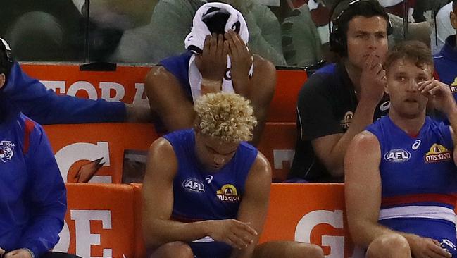 Lin Jong (back) was in tears on the bench after injuring his knee in the opening quarter. Picture: Michael Klein