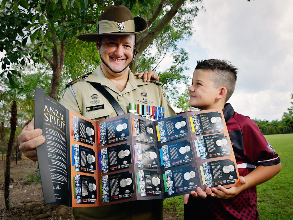 1st Aviation Regiment's Major Kade Coble and son Lachlan Coble with the Anzac Spirit official 2018 coin collection that will be available through the <i>NT News </i>and <i>Sunday Territorian</i>. Picture: Michael Franchi
