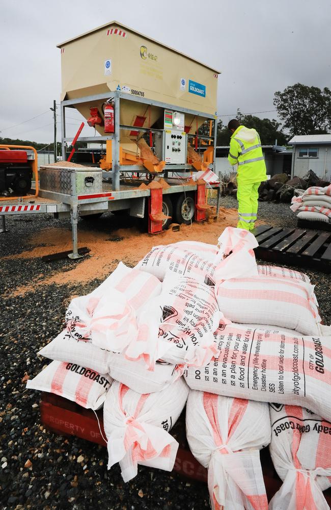 Gold Coast Council officers assist locals with free sand bags at a designated sand bagging station at Bilinga on the southern end of the Gold Coast after heavy torrential rain fell on the city overnight causing localised flooding. NCA NewsWire / Scott Powick