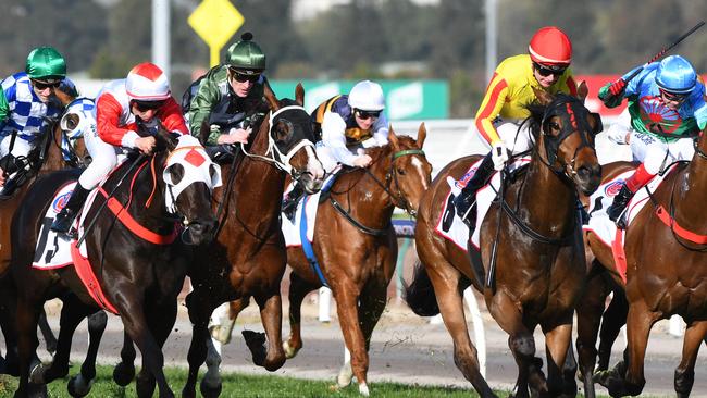 Mystic Journey (white and red) couldn’t run down Gatting (yellow and read) in the Makybe Diva Stakes. Picture: AAP