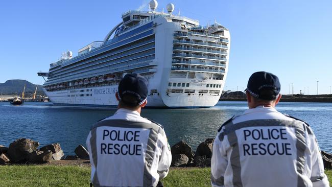 NSW Police Rescue officers look on as the Ruby Princess, with crew only on-board, docks at Port Kembla in Wollongong on Friday. Picture: AAP / Dean Lewins