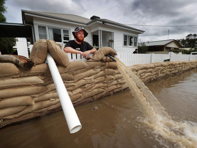 Tom Lee takes a break from shoring up and pumping water out of his property. Picture: David Caird