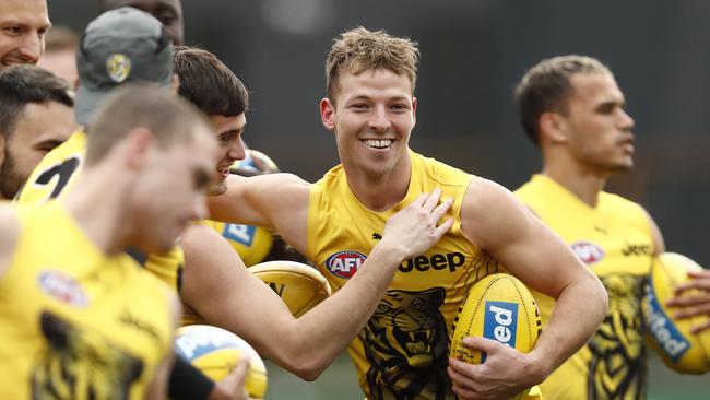 Teammates congratulate Jake Aarts ahead of his hard-earned AFL debut last season.