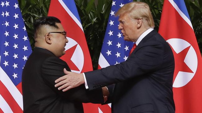 Donald Trump shakes hands with Kim Jong-un at the start of their summit. Picture: AP.