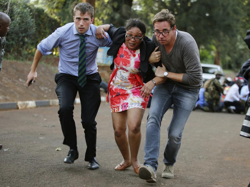 People take cover after the attack. Picture: AP Photo/Brian Inganga