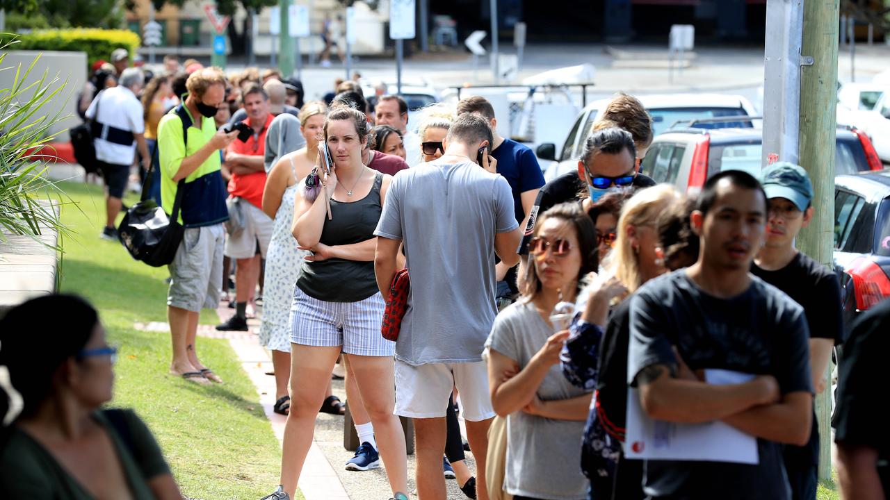 Lines of people wait at Southport Centrelink. Picture: Adam Head.