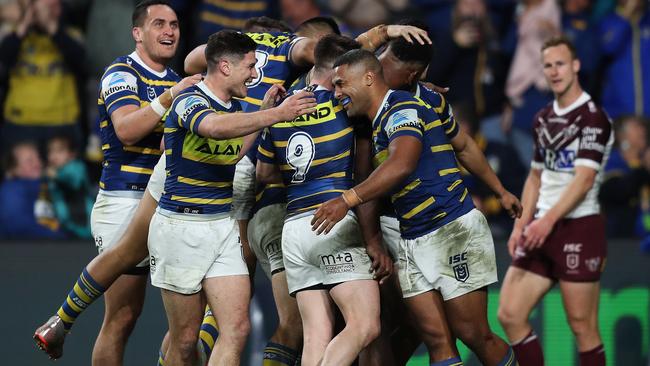 Parramatta players celebrate Parramatta's Maika Sivo's third try as Manly's Daly Cherry-Evans looks on during the Parramatta v Manly NRL match at Bank West Stadium, Parramatta. Picture: Brett Costello