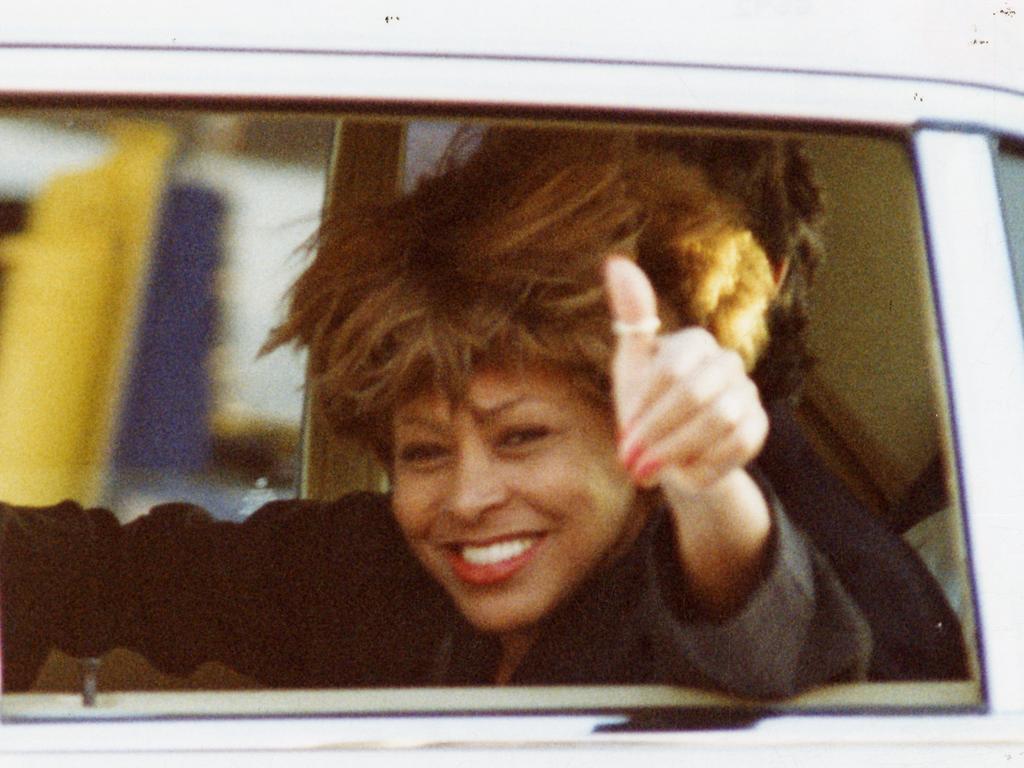 Tina Turner waves from a car as she arrives at Adelaide Airport for her concert at the Australian Grand Prix in November 1993.