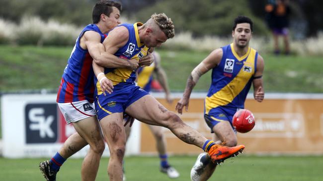 Williamstown’s Brett Bewley is tackled by Port Melbourne’s Mitch Hayes Picture: Richard Serong