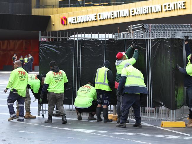 Teams build security fences ahead of the Land Forces expo. Picture: David Crosling