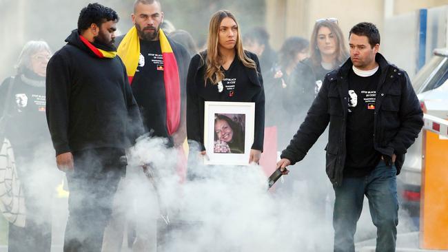 The family of Tanya Day (centre: Warren Stevens and Apryl Day) who died in Police custody take part in a traditional smoking ceremony as they make their way down to the Victorian coroners court for an inquiry into the Aboriginal woman’s death. Picture: Aaron Francis/The Australian