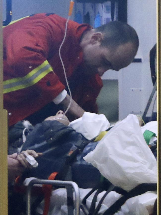 A firefighter attends an injured person in an ambulance after a truck ran into a crowded Christmas market and killed several people in Berlin, Germany. Picture: AP