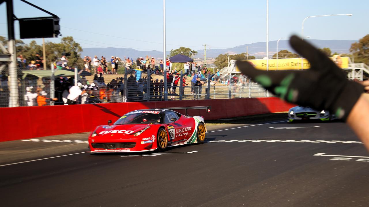 Craig Lowndes takes the chequered flag to win the 2014 race.