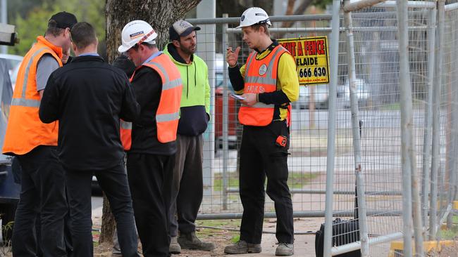 SafeWork SA inspectors interview workers at the scene. Picture: Dylan Coker