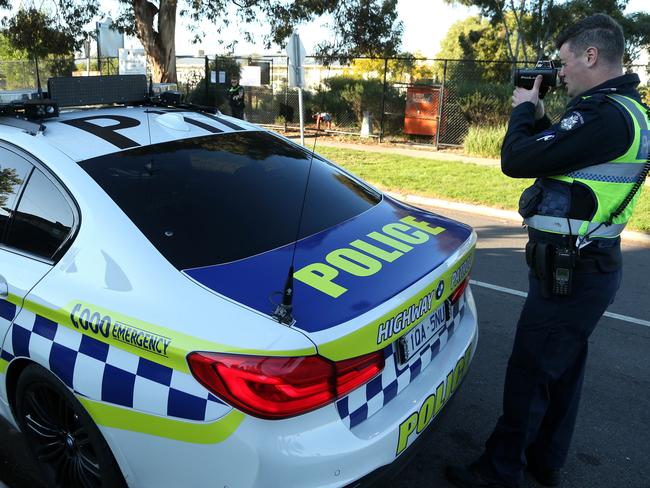 Acting Sergeant Stephen Little monitors traffic speed on York Street outside Glenroy West Primary School on Tuesday, June 9, 2020, in Glenroy, Victoria, Australia. Picture: Hamish Blair