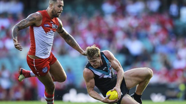 Tom Jonas tries to escape the clutches of Swans superstar Lance Franklin at the SCG on Sunday. Picture: Brett Hemmings/AFL Media/Getty Images