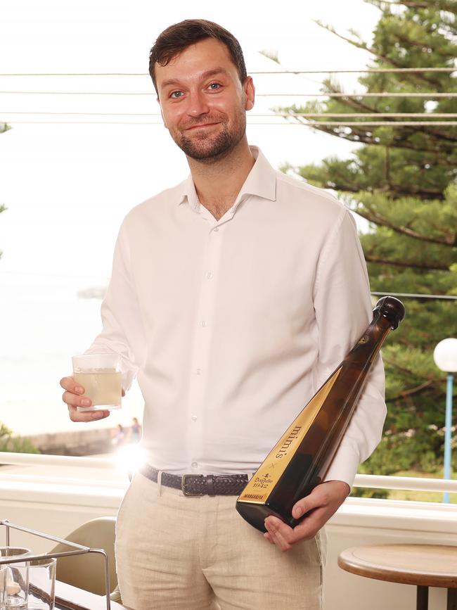 Bar manager Rhys Budd with the drink. The magnum is worth $1250. Picture: Rohan Kelly