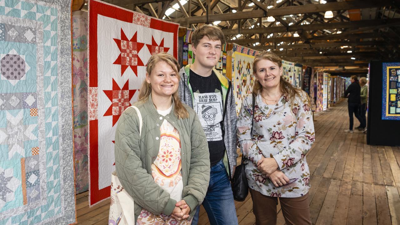 Checking out the work on show by Toowoomba Quilters Club members are (from left) Amber Cook, Keegan Zischke and Janine Zischke at Craft Alive at the Goods Shed, Sunday, May 22, 2022. Picture: Kevin Farmer