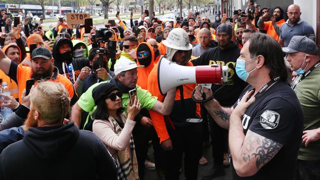 CFMEU Victorian secretary John Setka tries to quell protesters outside his union’s Melbourne office on Monday. Picture: David Crosling