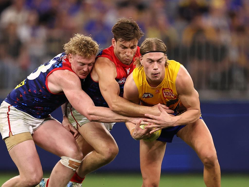 PERTH, AUSTRALIA - MAY 19: Harley Reid of the Eagles gets tackled by Clayton Oliver and Jack Viney of the Demons during the round 10 AFL match between Waalitj Marawar (the West Coast Eagles) and Narrm (the Melbourne Demons) at Optus Stadium, on May 19, 2024, in Perth, Australia. (Photo by Paul Kane/Getty Images)