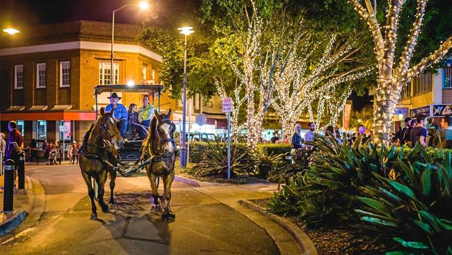 A horse and carriage navigates the intersection at 5 ways during one of the Mary Street celebrations in Gympie. Picture: Leeroy Todd