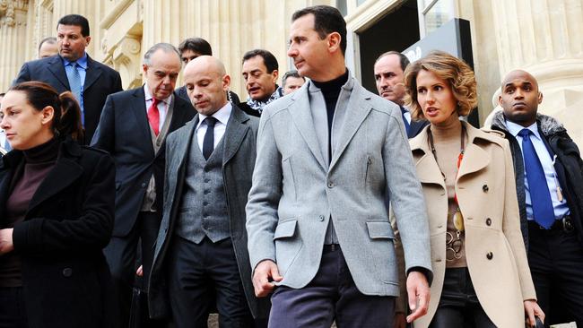 Syria's ousted president Bashar al-Assad (C), his wife Asma (R) and French Culture Minister Frederic Mitterrand (2dL) leave the Grand Palais after their visit to an exhibition in Paris on December 11, 2010. Picture: AFP