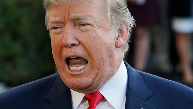 US President Donald Trump speaks to reporters as he and First Lady Melania Trump make their way to board Marine One before departing from the South Lawn of the White House on November 3, 2017 in Washington, DC. Trump is embarking on a 11-day tour of Asia. / AFP PHOTO / Mandel NGAN