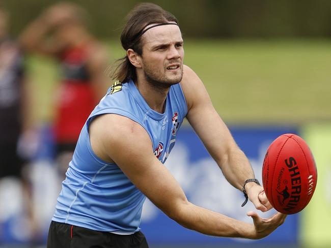 MELBOURNE, AUSTRALIA - APRIL 11: Hunter Clark of the Saints handballs during a St Kilda Saints AFL training session at RSEA Park on April 11, 2024 in Melbourne, Australia. (Photo by Darrian Traynor/Getty Images)