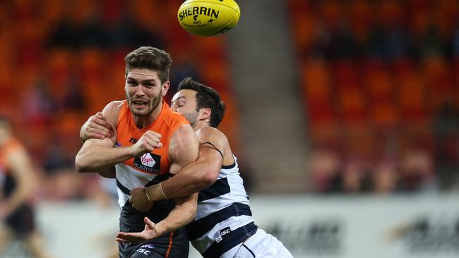 Greater Western Sydney's Tomas Bugg tackled by Geelong's Jimmy Bartel during AFL match GWS Giants v Geelong Cats at Spotless Stadium, Homebush. pic. Phil Hillyard