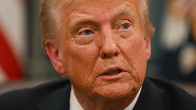 US President Donald Trump speaks to journalists as he signs executive orders in the Oval Office of the WHite House in Washington, DC, on January 20, 2025. (Photo by Jim WATSON / POOL / AFP)