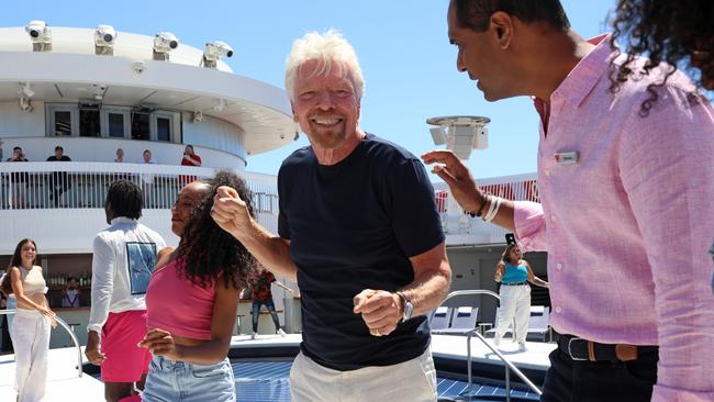 Sir Richard is currently in Australia to celebrate the launch of his ship Resilient Lady entering Aussie shores for he first time. Here is he dancing on the yacht-inspired ship on Sydney Harbour. Picture: NCA NewsWire / Damian Shaw