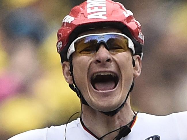 TOPSHOTS Germany's Andre Greipel celebrates as he crosses the finish line at the end of the 194 km sixth stage of the 101st edition of the Tour de France cycling race on July 10, 2014 between Arras and Reims, northern France. AFP PHOTO / LIONEL BONAVENTURE