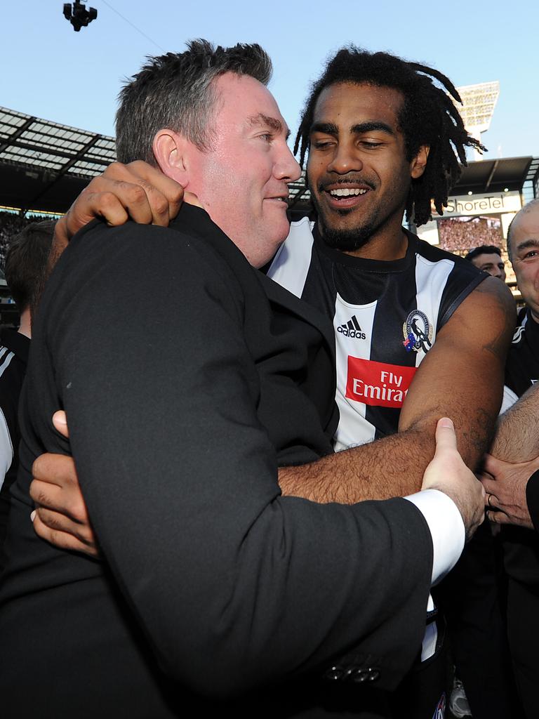 Heritier Lumumba celebrates with McGuire after the 2010 premiership.