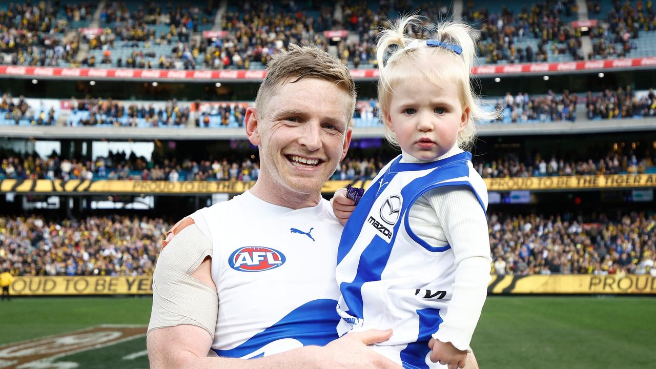 MELBOURNE, AUSTRALIA - AUGUST 19: Jack Ziebell of the Kangaroos and daughter Pippa embrace after his final match during the 2023 AFL Round 23 match between the Richmond Tigers and the North Melbourne Kangaroos at Melbourne Cricket Ground on August 19, 2023 in Melbourne, Australia. (Photo by Michael Willson/AFL Photos via Getty Images)