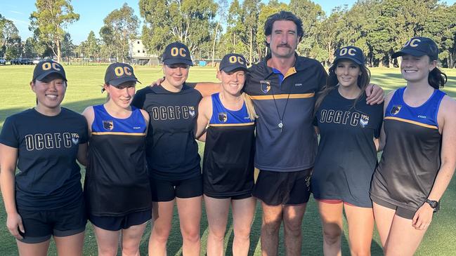 Old Carey women's football coach Ryan Dobson with his players at training. Picture: Supplied.