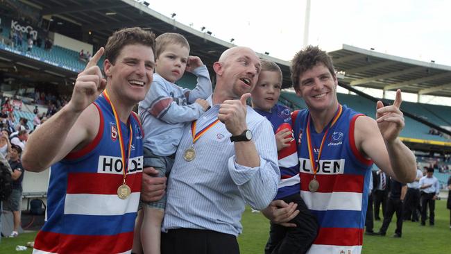 Roy Laird with the Gowan brothers after the 2010 SANFL grand final win against Norwood at Football Park. Picture: Simon Cross