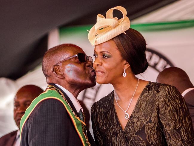 Robert Mugabe kisses his wife during the country's 37th Independence Day celebrations at the National Sports Stadium in Harare in April. Picture: AFP