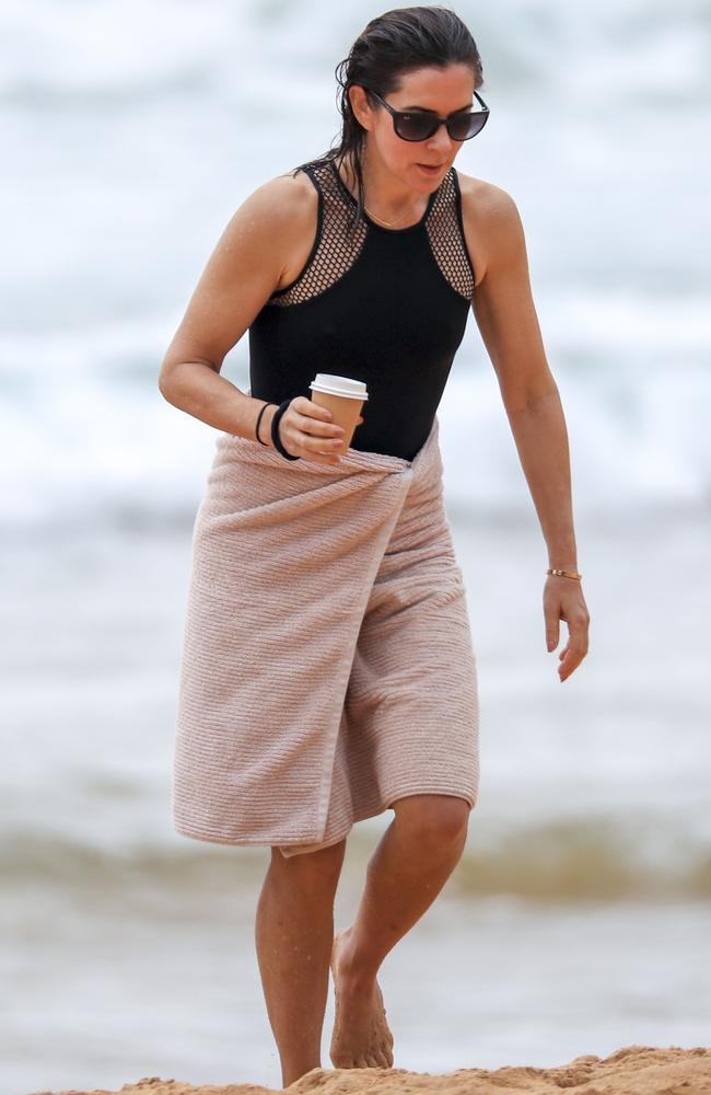 She’s not letting go of that coffee. Princess Mary and her royal family hit Sydney’s Palm Beach for a dip before they head to Tasmania for an Aussie Christmas. Picture: Media Mode