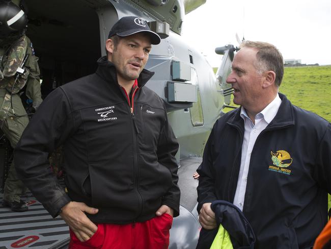 New Zealand Prime Minister John Key, right, talks with former All Blacks captain Richie McCaw as he flies into help with the rescue effort following the major 7.8 quake. Picture: Mark Mitchell/New Zealand Herald Pool Photo via AP.