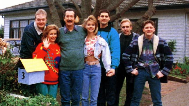 The cast of the film outside the house, including Michael Caton as Darryl Kerrigan.