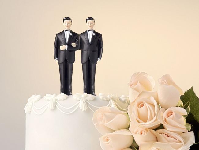 Homosexual wedding cake topper showing two grooms, men and rose flowers. THINKSTOCK
